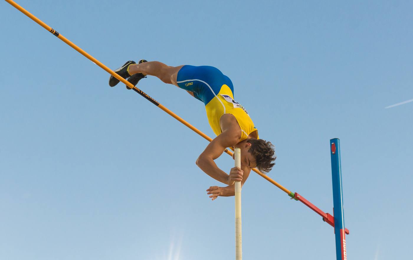 Armand Duplantis inverted above the crossbar clearing 6.00 m at Stockholm Stadium, August 2019